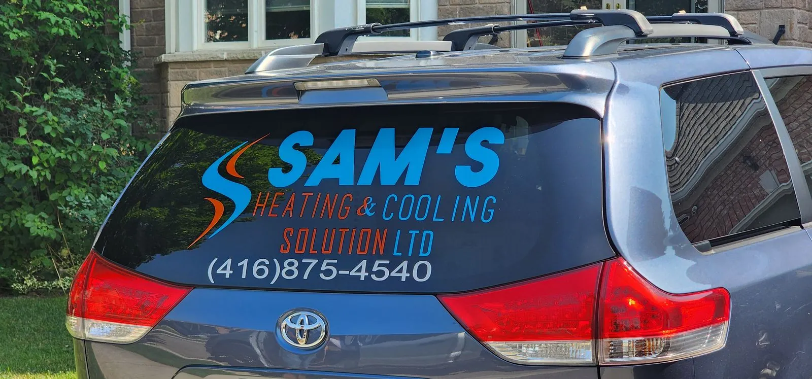 Rear-window lettering on the Sam's Heating & Cooling Sienna